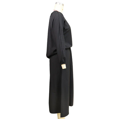 Elegant two-piece set with oblique shoulder blouse and midi skirt in black colour