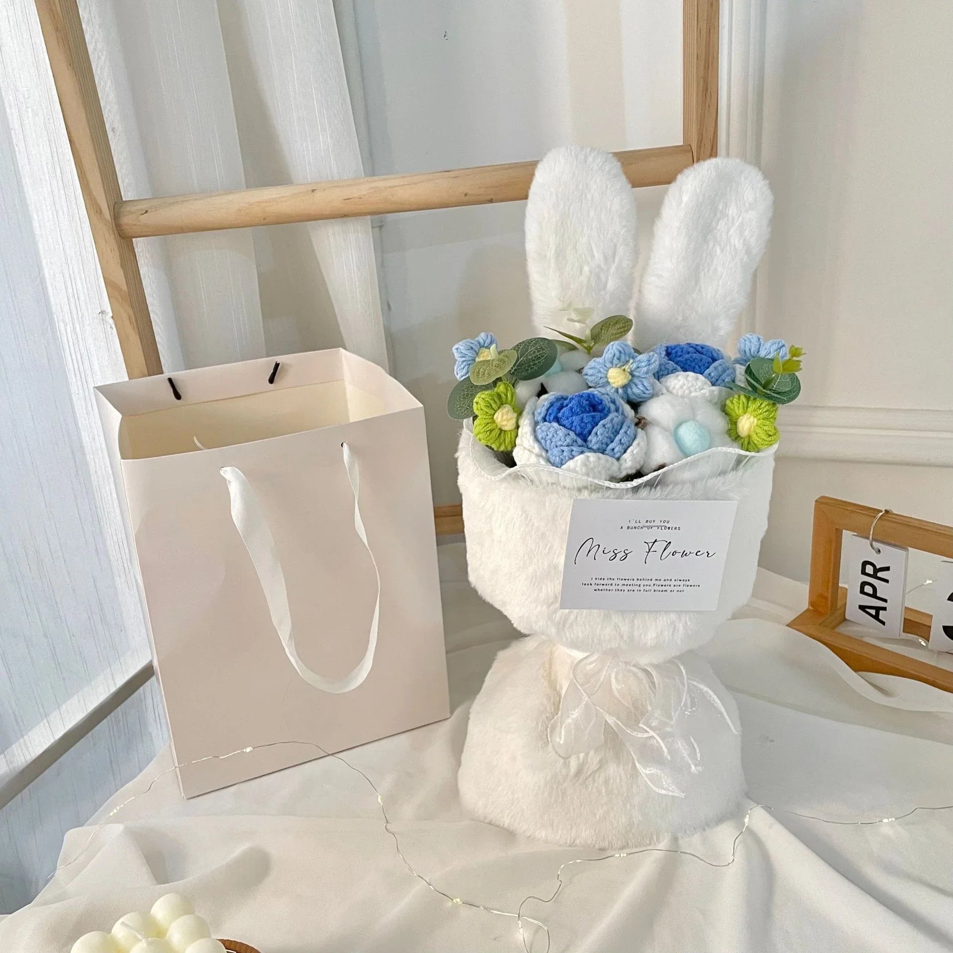 A delightful knitted rabbit bouquet doll in vibrant colours, featuring soft plush materials and a charming design