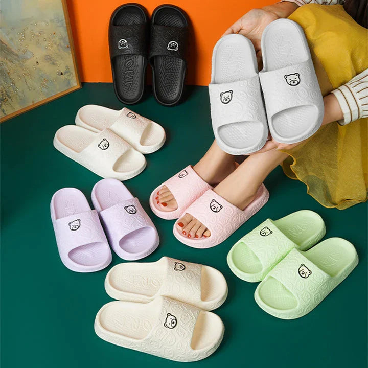 Cosy bear paw slippers in purple colour with soft, plush lining for relaxing indoor wear