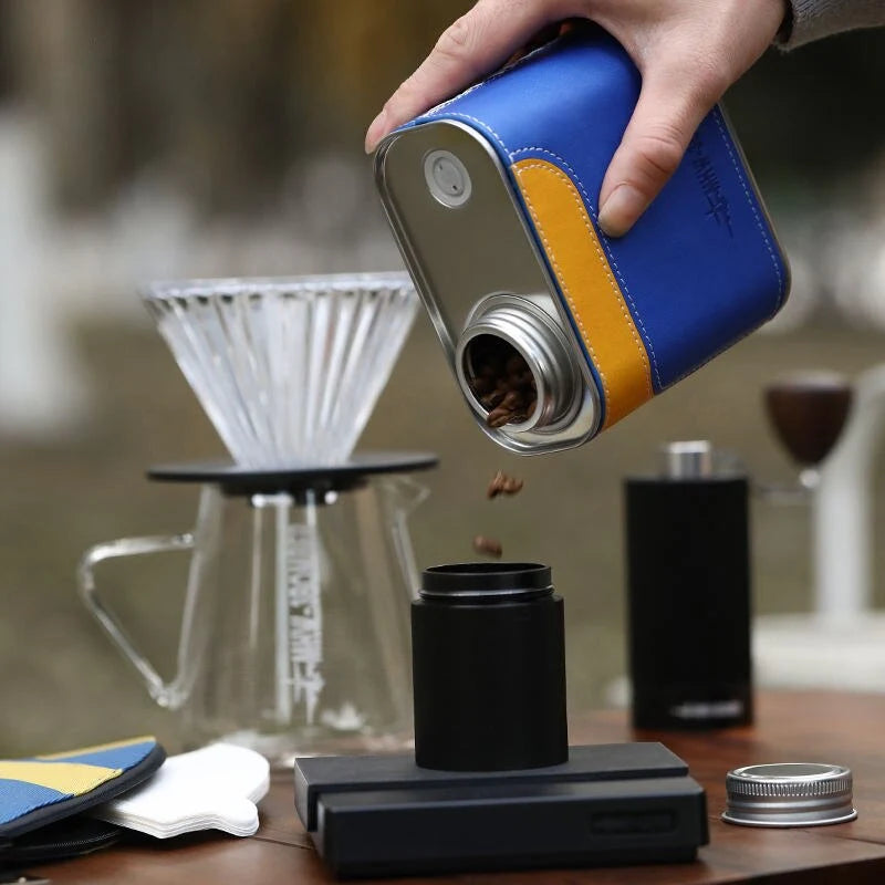 Airtight metal coffee and tea canister with portable filter paper storage, perfect for camping and home use