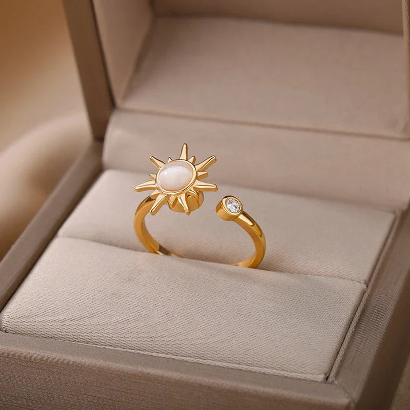 Adjustable stainless steel ring with rotating sun opal centerpiece, offering a modern and sophisticated geometric design for fashionable women