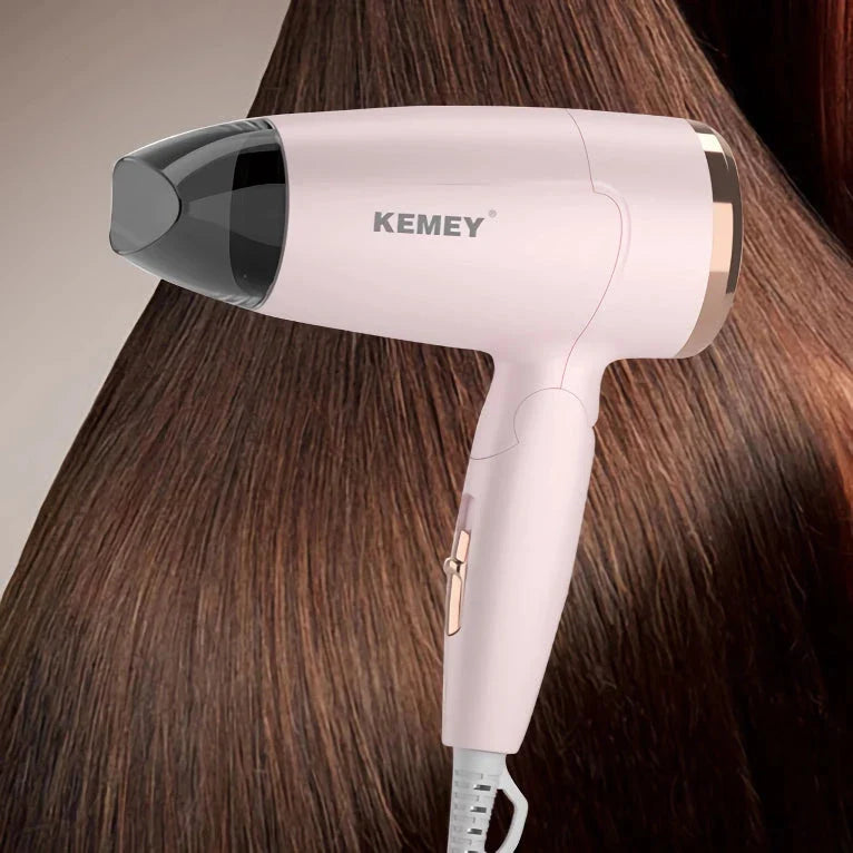 Compact foldable hair dryer with powerful 950W motor, adjustable settings, and lightweight, portable design for travel and student use