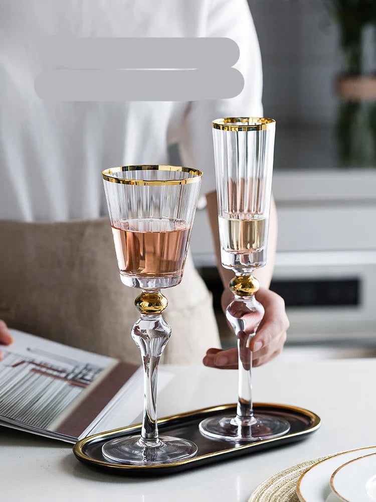 Elegant crystal wine glasses with a gold vertical pattern design, perfect for enjoying your favourite wines in style.
