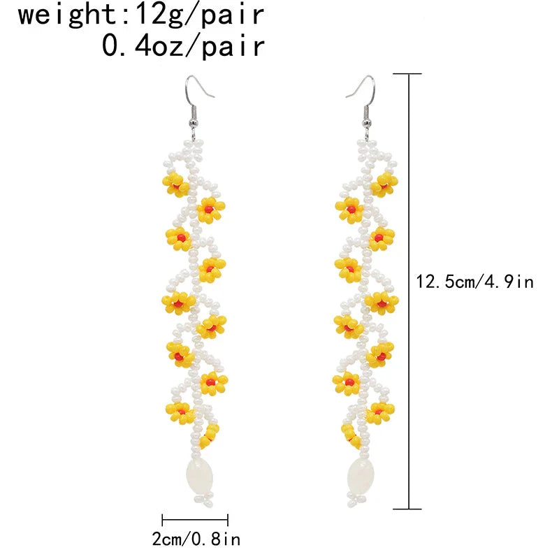 Elegant bohemian resin long tassel drop earrings in a vibrant yellow colour, featuring a mesmerising floral pattern and graceful movement