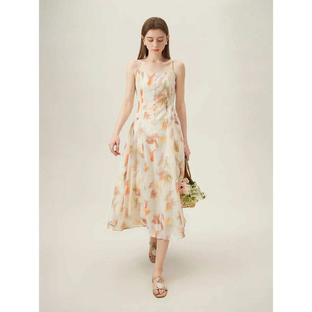 Elegant floral sleeveless summer dress in orange with a flattering A-line silhouette, perfect for British summer occasions.