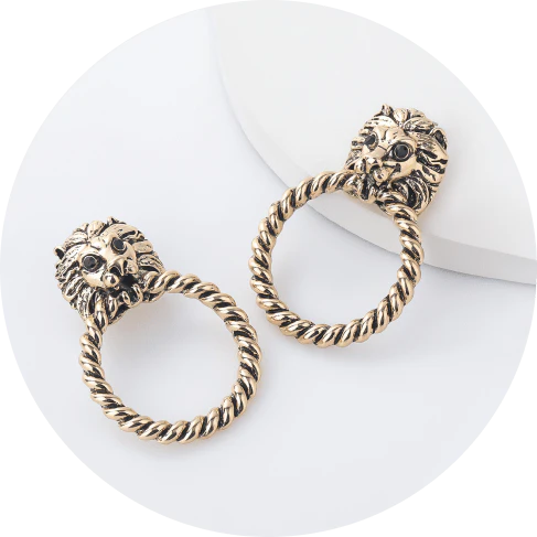 Close-up of the magnificent lion head stud earrings with a twisted hoop design, exuding power and confidence.