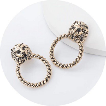 Close-up of the magnificent lion head stud earrings with a twisted hoop design, exuding power and confidence.