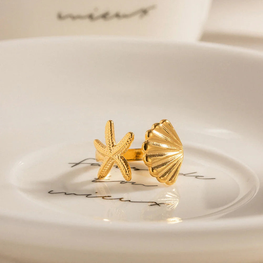 Adjustable stainless steel ring with starfish and shell accents, perfect for beach and casual wear