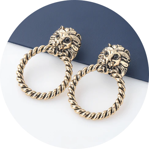 Close-up of the magnificent lion head stud earrings with a twisted hoop design, exuding power and confidence.