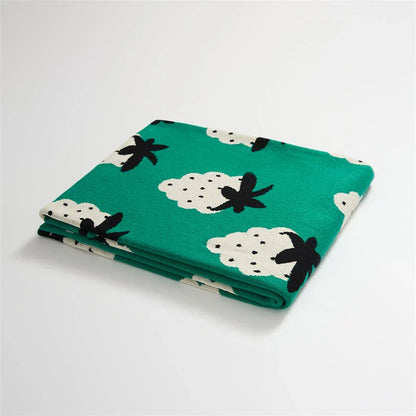 A cosy grape-patterned cotton blanket with a sophisticated design, perfect for relaxation and home decor