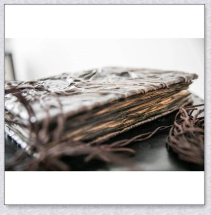 A haunting Necronomicon book with an embossed monster cover, aged pages, and a leathery, deathly texture