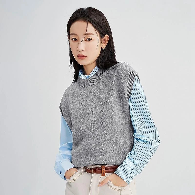 A cozy and chic knitted sleeveless vest in various colours, featuring a straight silhouette and a blend of premium materials for warmth and comfort.