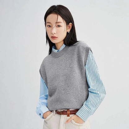 A cozy and chic knitted sleeveless vest in various colours, featuring a straight silhouette and a blend of premium materials for warmth and comfort.