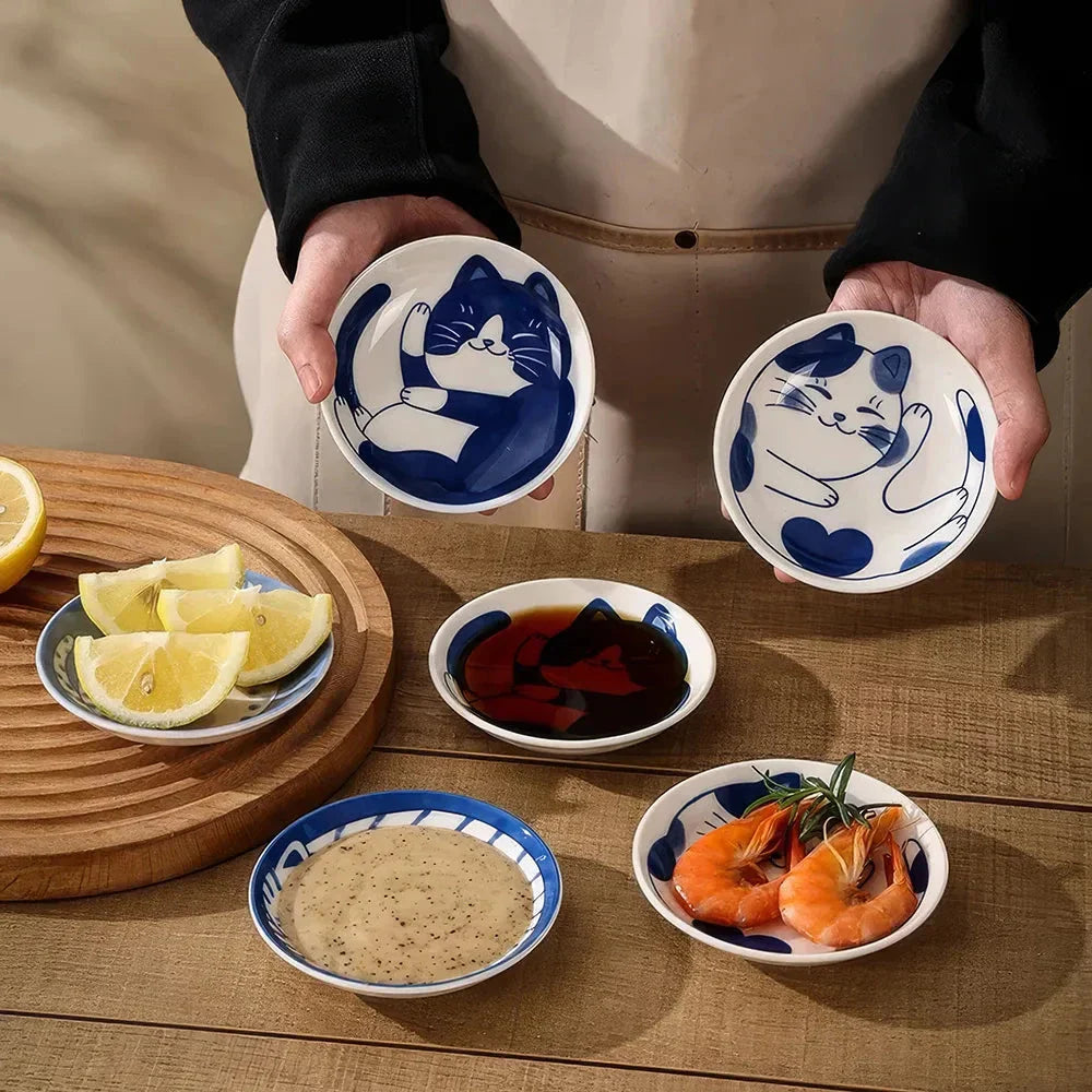 Charming Japanese ceramic sauce dish with a lucky cat design, perfect for serving sauces, sushi, and more.