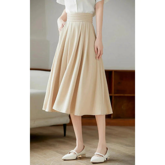 Elegant high-waisted pleated skirt with pockets in apricot colour, made from a blend of acrylic, cotton, and polyester for comfort and durability.