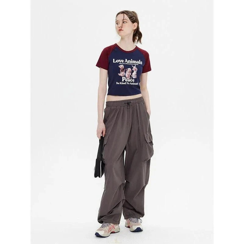 Enchanting animal print crop top with raglan sleeves and distressed details, perfect for casual summer outfits.