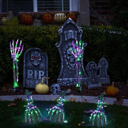 Solar-powered Halloween ground lamp with hand-shaped LED lights in purple and green colours, creating a spooky ambience in an outdoor courtyard