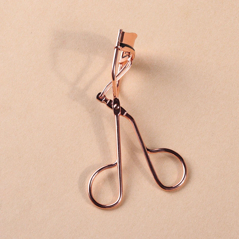 Rose gold eyelash curler with a silicone pad for gentle, long-lasting lash curling