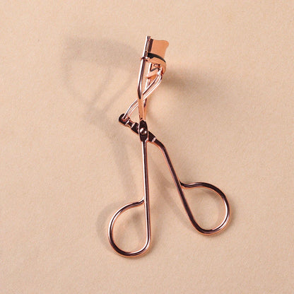 Rose gold eyelash curler with a silicone pad for gentle, long-lasting lash curling