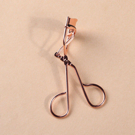 Rose gold eyelash curler with a silicone pad for gentle, long-lasting lash curling