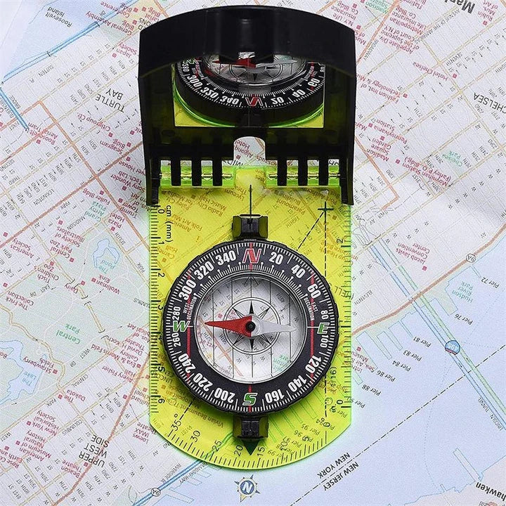 Multifunctional outdoor compass with scale, map ruler, mirror, and durable yellow casing for reliable navigation in the wilderness