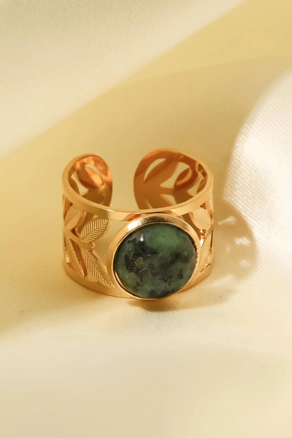 Elegant 18K gold-plated malachite leaf ring in a flat lay, studio style photograph