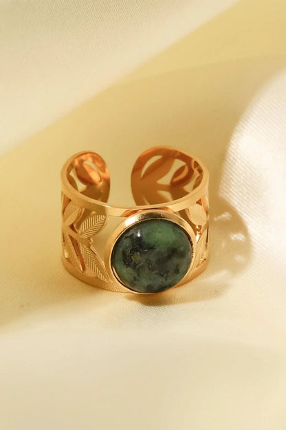 Elegant 18K gold-plated malachite leaf ring in a flat lay, studio style photograph