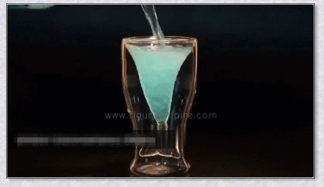 A transparent glass mug with a decorative mermaid tail design, perfect for enjoying a range of beverages in style.