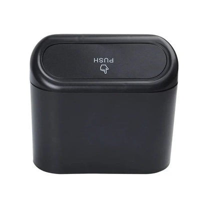 A compact black car bin with a press-type lid, designed to hang on the door panel and store garbage securely