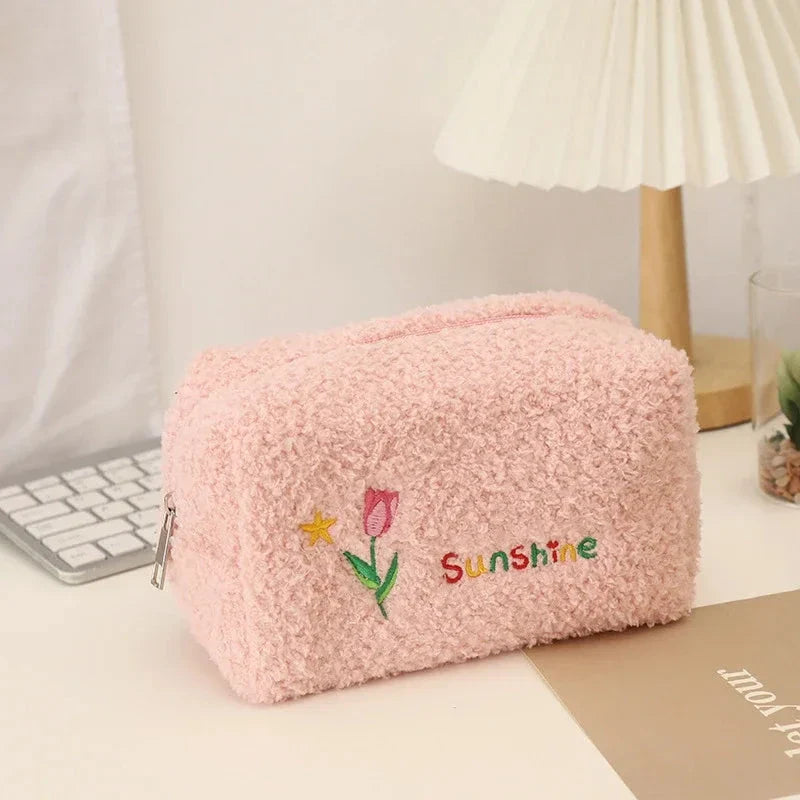 Elegant embroidered flowers cosmetic pouch made of soft, plush material in ivory colour