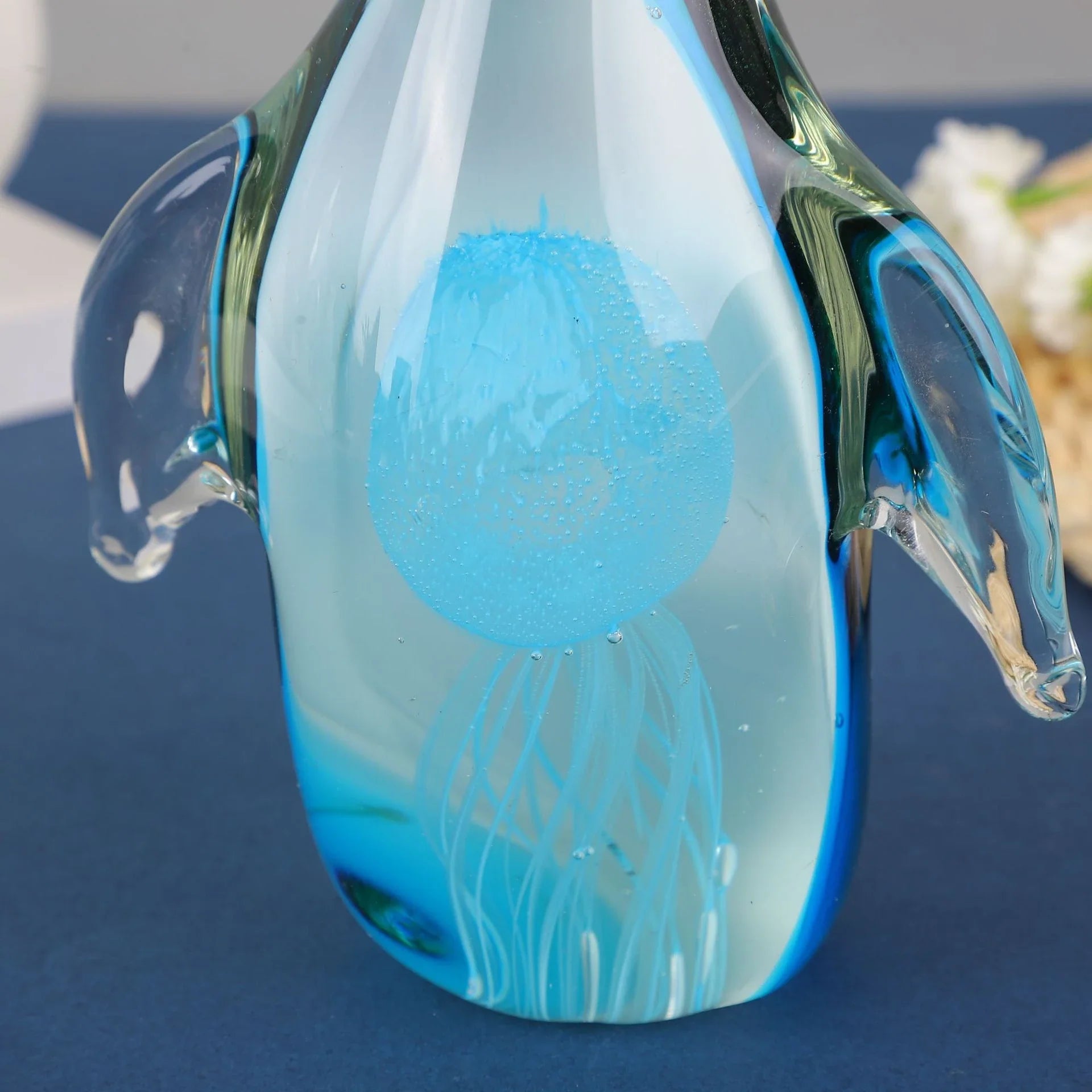Exquisite handcrafted glass penguin ornament with a striking green-backed design, showcasing the beauty of marine life