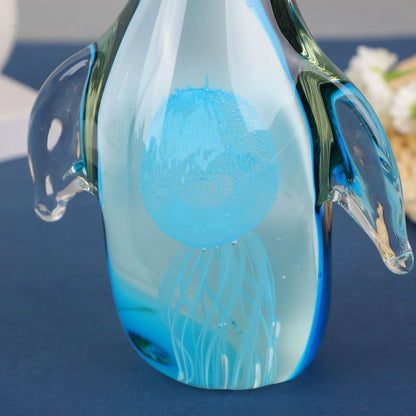 Exquisite handcrafted glass penguin ornament with a striking green-backed design, showcasing the beauty of marine life