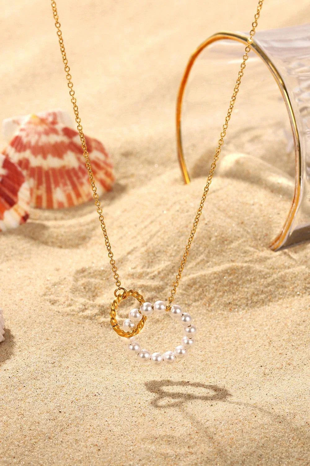 Elegant 18K gold-plated pearl hoop necklace with a lustrous synthetic pearl centrepiece