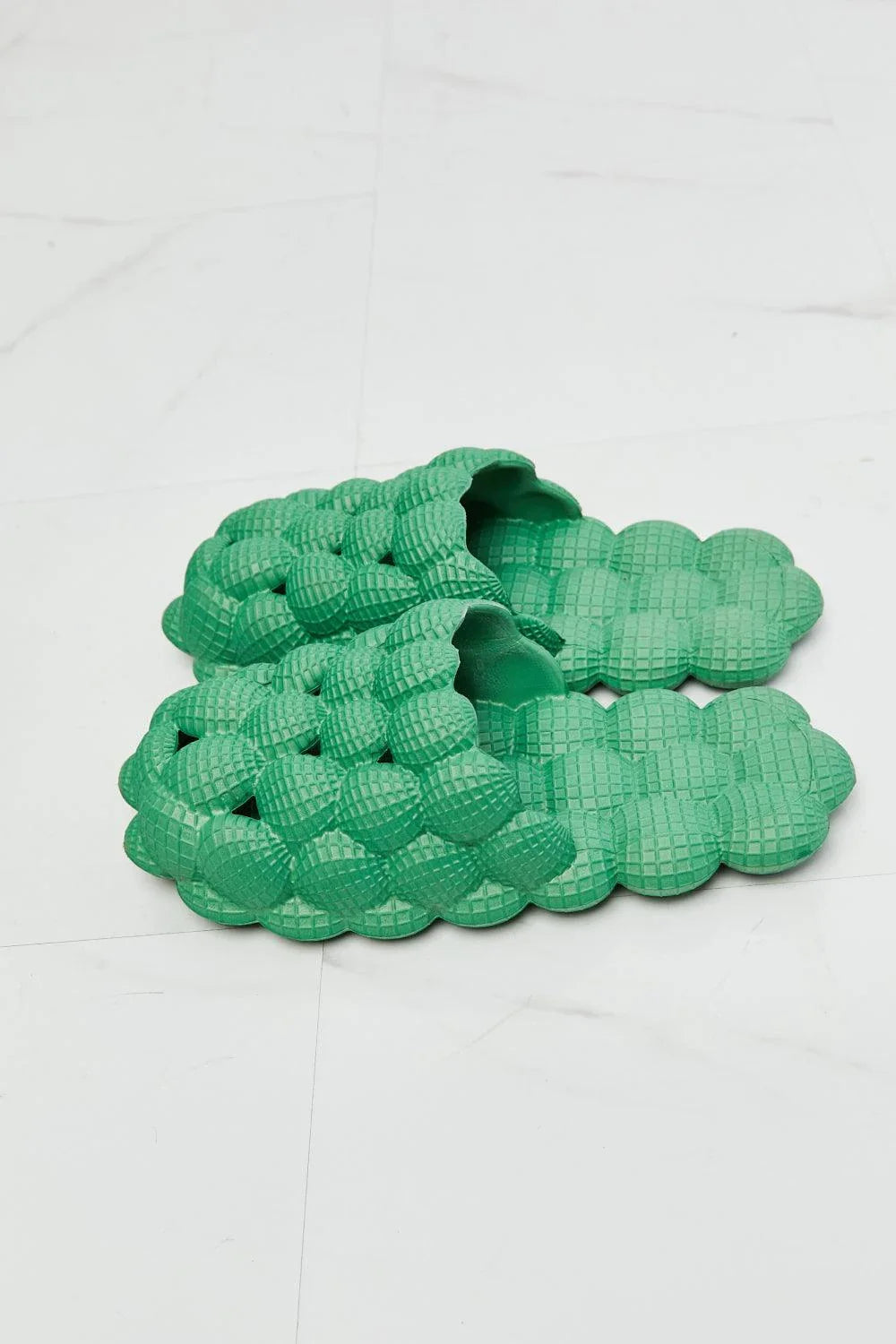 Cosy green bubble slide slippers with plush cushioning and slip-on design