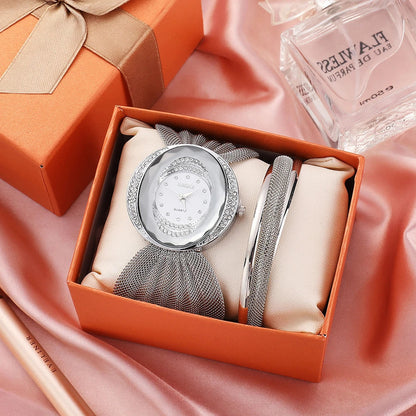 Elegant women's wrist watch with a floral dial design and a gleaming gold and silver mesh strap