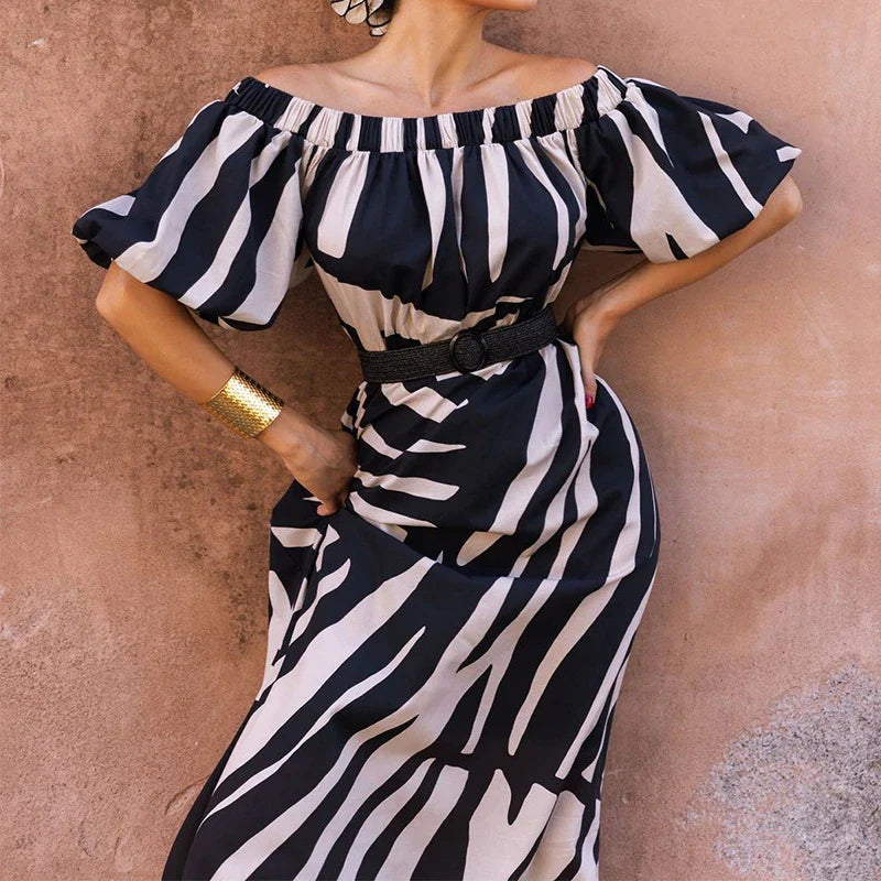 Elegant floral-print off-shoulder midi dress in black, showcasing a feminine A-line silhouette and premium polyester construction