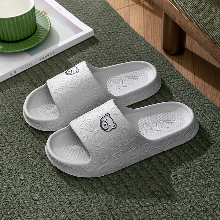 Cosy bear paw slippers in purple colour with soft, plush lining for relaxing indoor wear