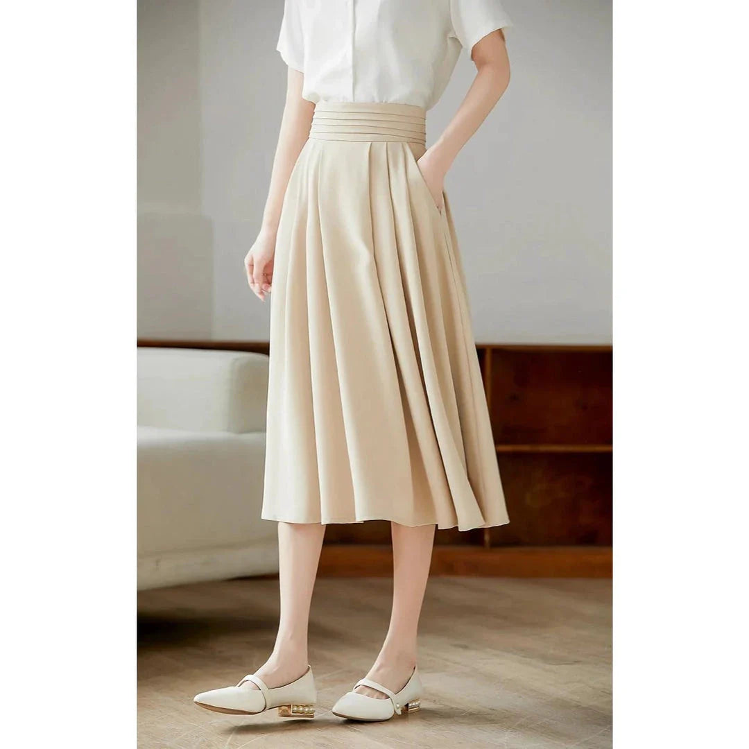 Elegant high-waisted pleated skirt with pockets in apricot colour, made from a blend of acrylic, cotton, and polyester for comfort and durability.