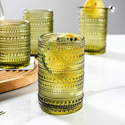 Set of 4 elegant retro-inspired drinking glasses with unique bead design and comfortable grip