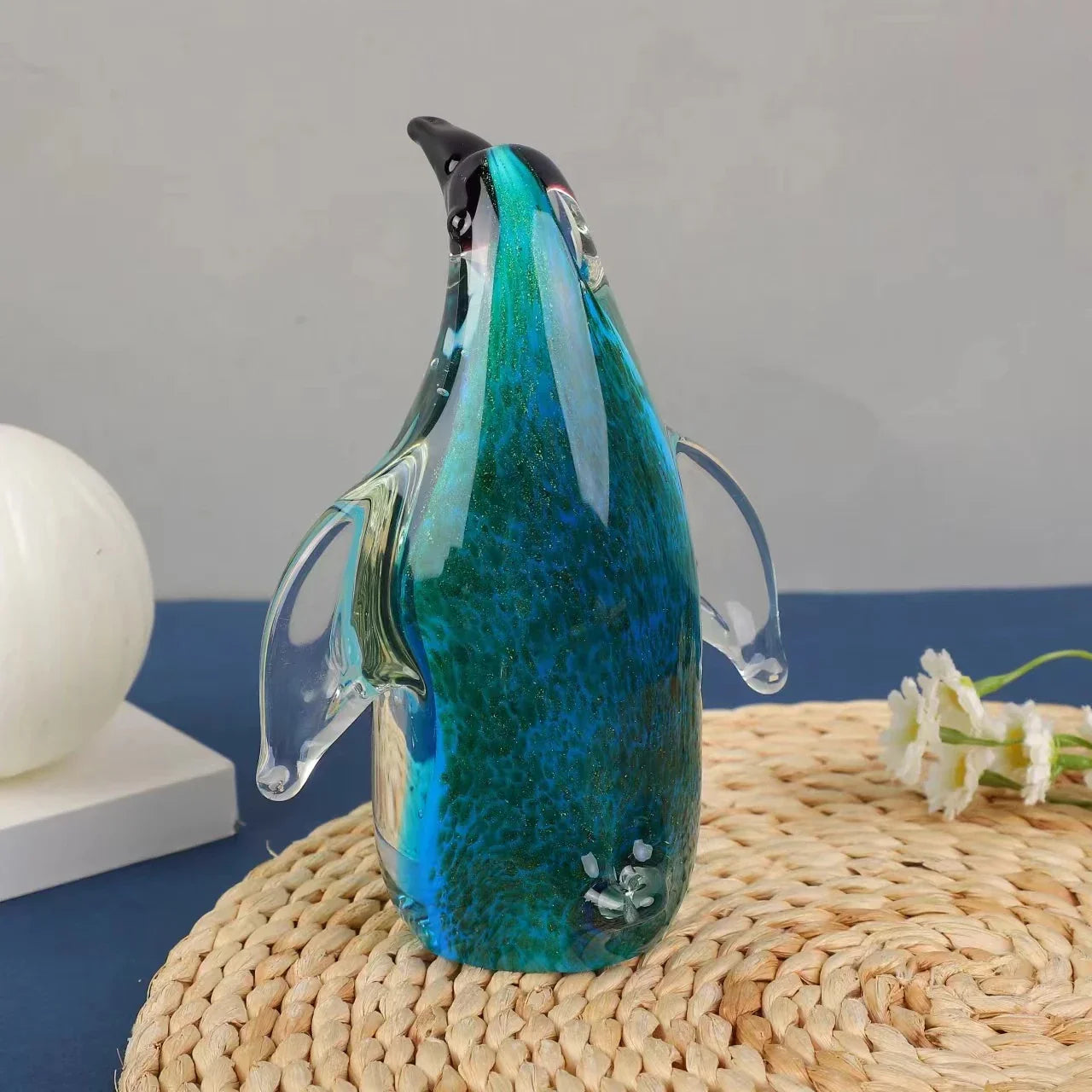 Exquisite handcrafted glass penguin ornament with a striking green-backed design, showcasing the beauty of marine life