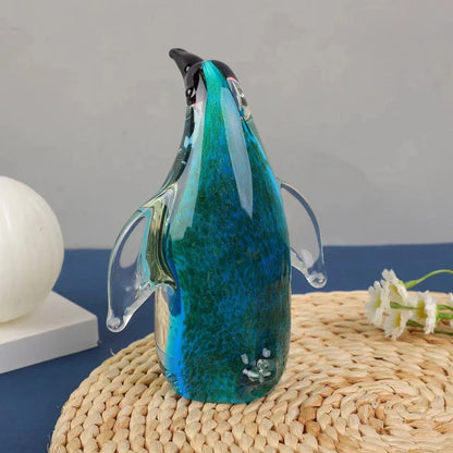 Exquisite handcrafted glass penguin ornament with a striking green-backed design, showcasing the beauty of marine life