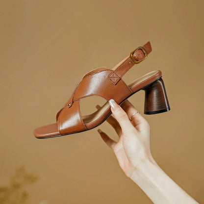 Elegant leather high heel sandals in khaki colour for women, featuring a 5.5 cm square heel, secure buckle strap, and sleek design.