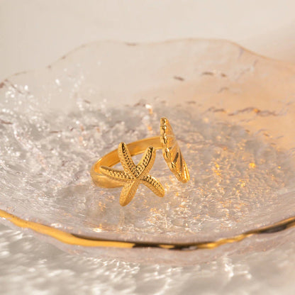 Adjustable stainless steel ring with starfish and shell accents, perfect for beach and casual wear