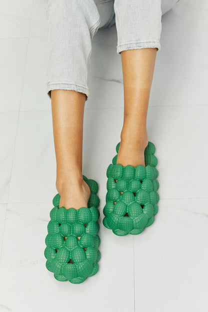Cosy green bubble slide slippers with plush cushioning and slip-on design