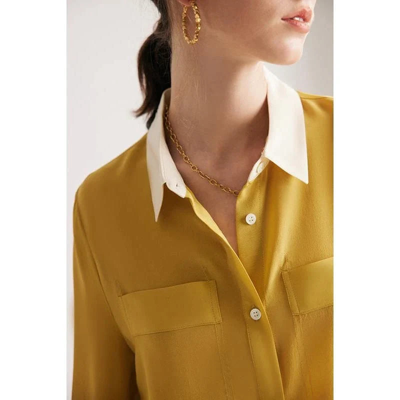 A chic and elegant silk crepe de chine blouse in a timeless solid pattern, perfect for professional and casual wear.