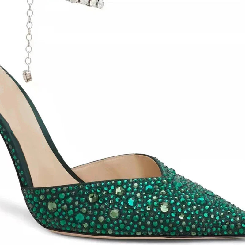 Elegant stiletto sandals with rhinestone chain embellishment, showcasing a sleek pointed toe design and matte finish for a sophisticated British-inspired look.