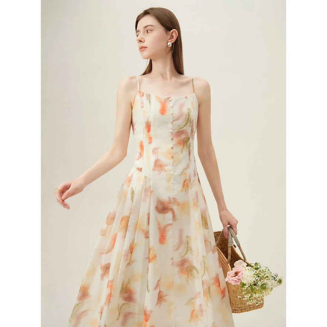 Elegant floral sleeveless summer dress in orange with a flattering A-line silhouette, perfect for British summer occasions.