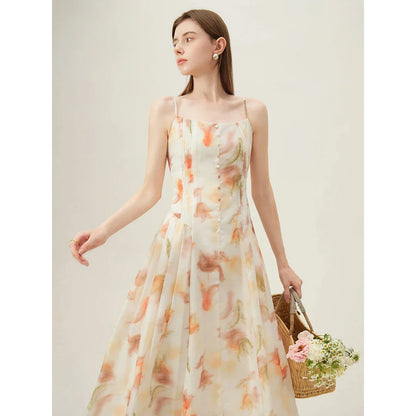 Elegant floral sleeveless summer dress in orange with a flattering A-line silhouette, perfect for British summer occasions.