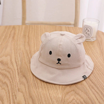 Adorable baby sun hat with cute bear ears, made of soft cotton and durable polyester for sun protection and comfort.