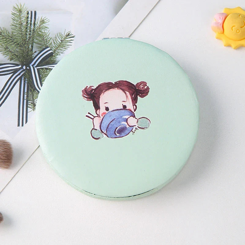 Compact portable foldable makeup mirror with cute cartoon prints for on-the-go beauty touch-ups